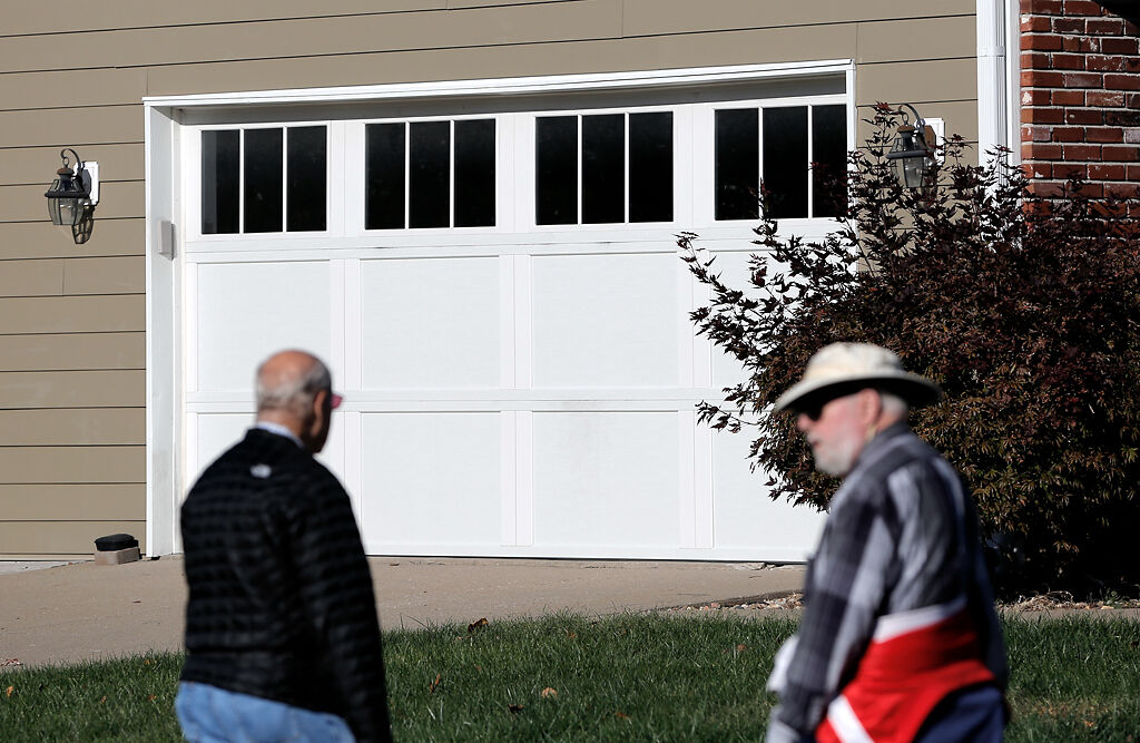 Brian Foster, left, and Jerry Murrell walk around the neighborhoods off of Green Meadows Dr.